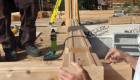 Setting the first logs in place. Note the saddle notch corners. This home was also pre-drilled for the lag holes and all electrical work.