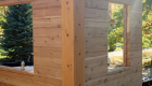 An inside corner with the post. The post corner and the flat-flat log give the inside of this home a very clean look. Note the pre-drilled holes for the electrical components.