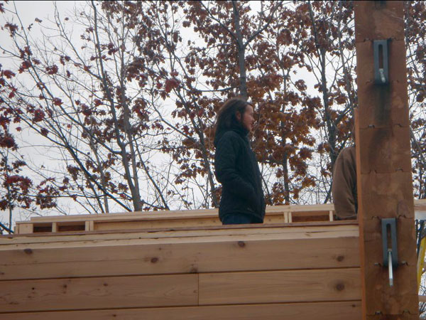 A happy homeowner watches the progress of the build.