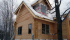 The outside of the flat-flat milled logs. Siding on gable windows still under construction.