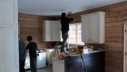 Installing the kitchen cabinets.