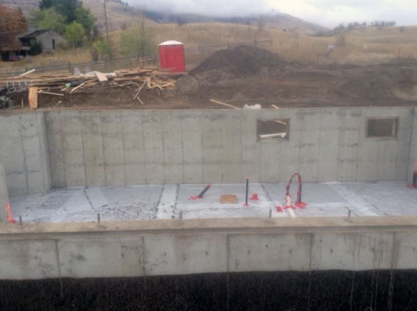 Basement walls and slab poured. Roughed in plumbing completed.