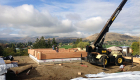 Day 2 of log stack. Note the builder brought in a crane to expedite the process.