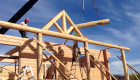 Day 4 -- hand crafted log porch system being installed.