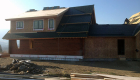 Final roof materials and windows being installed.