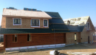 Final roof materials and windows being installed.