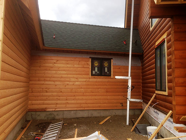 Siding and window trim being installed -- yet to be stained.