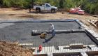 Compacting foundation prior to concrete slab being poured.