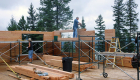Log walls going up -- note the use of scaffolding for ease of assembly.