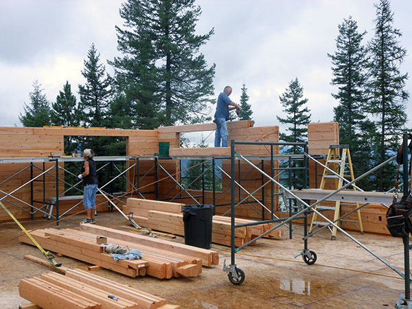 Log walls going up -- note the use of scaffolding for ease of assembly.