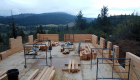 Log walls going up -- note the use of scaffolding for ease of assembly.