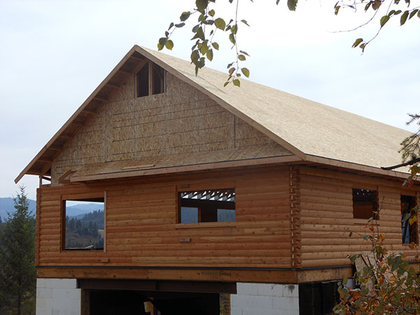 Roof sheeted -- eyebrow being built on gable end.