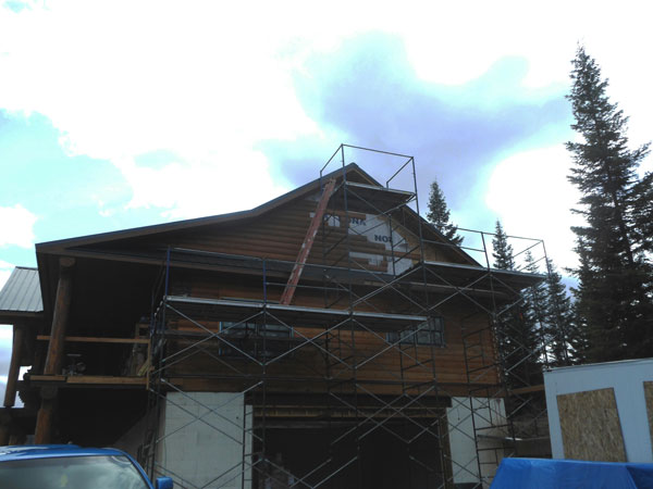 Gable end siding being installed -- note the scaffolding 5 high!!