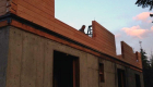 Construction of the precut log wall system.