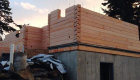 Construction of the precut log wall system.