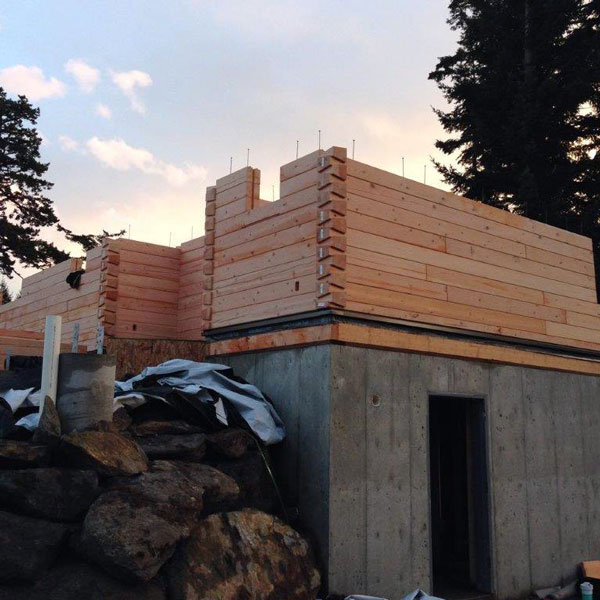 Construction of the precut log wall system.