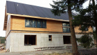 Windows going in, roof prepped for metal roofing.
