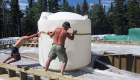 1300 gallon water storage tank being installed.
