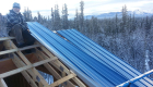 Metal roof under construction on a sunny winter day.