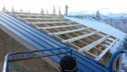 Metal roof under construction on a sunny winter day.