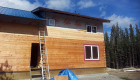 Installing siding on the upper level.